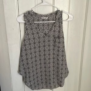 Black and white sleeveless patterned blouse